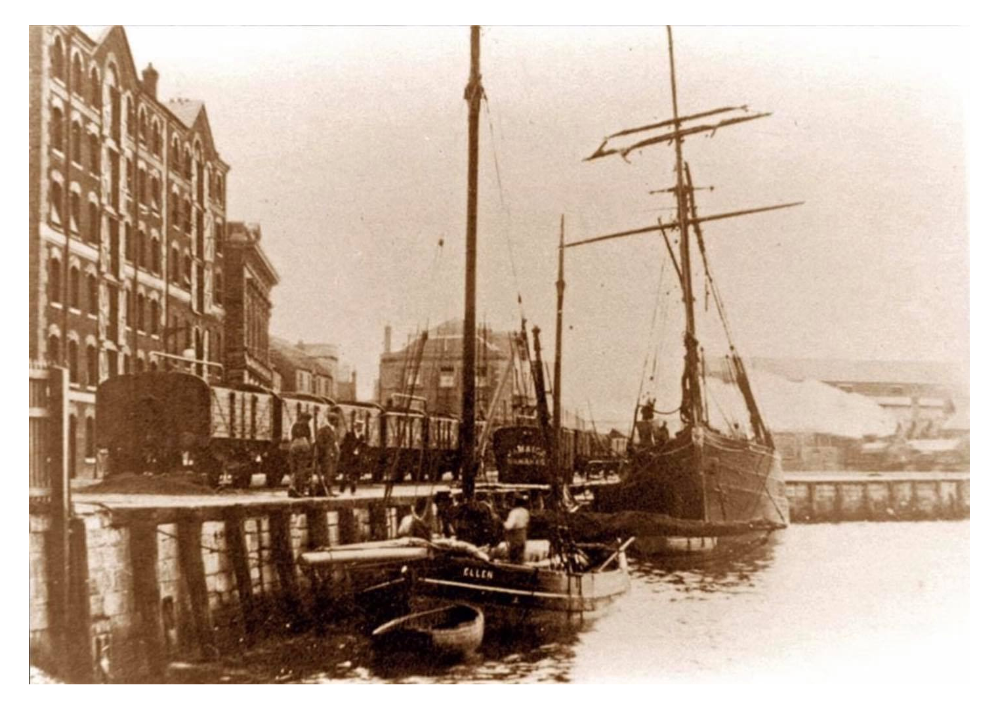 A clipper ship moored at the warehouse in the late 19th century